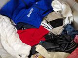 a pile of clothes in a basket on the floor
