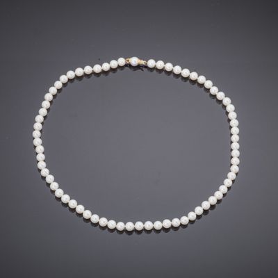 a cultured pearl necklace with a gold clasp