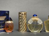 three bottles of perfume sitting next to each other on a table