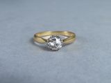 a close up of a gold ring with a diamond on it