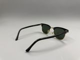 a pair of black and gold sunglasses on a white surface