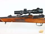 the rifle is sitting on a stand with a scope on top of it