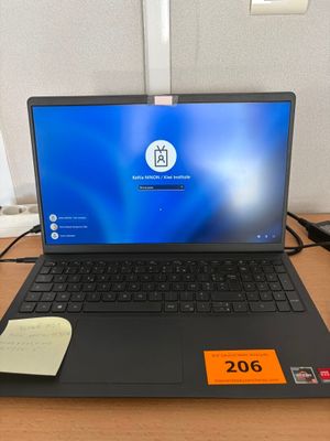 a laptop that is sitting on a desk with a price tag