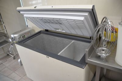 an open freezer sitting on a counter in a kitchen