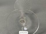a wine glass with a label on it sitting on a table