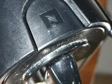 a close up view of a coffee maker with a cup on it
