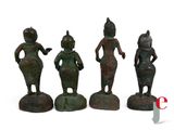 three bronze figurines of a woman and two men