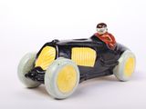 a figurine of a man driving a toy car
