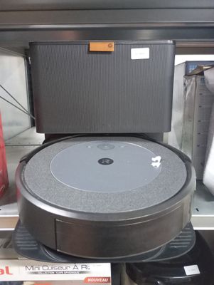 a black and silver robot sitting on a shelf in a store