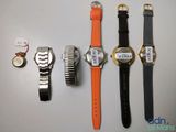 three watches are sitting next to each other on a table