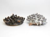 pair of ceramic hedgehogs on a white background