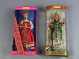 two dolls of different colors are in a box on a table