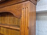 a large wooden bookcase with a glass door