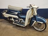a blue and white motor scooter parked in a garage