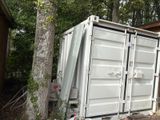 a large white container sitting in the middle of a yard