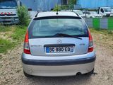 a small silver car parked on the side of the road
