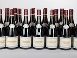 six bottles of wine are lined up in a row on a table