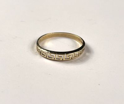a close up of a gold ring on a white surface