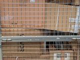 a cage with boxes on top of it and a sign in the middle of the cage