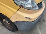 a yellow van that has been damaged and is parked in a parking lot