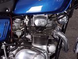 a blue honda motorcycle parked on the side of the road