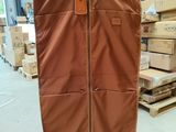 a suit case hanging on a hanger in a warehouse