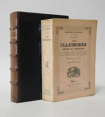 an old book sitting on top of a table next to a closed book