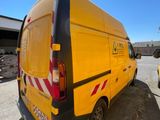 a yellow van that is parked in a parking lot