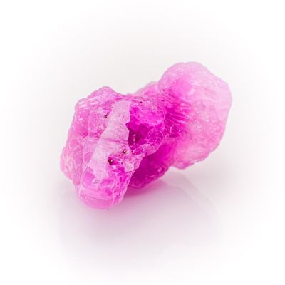 pink crystals on a white surface with a white background