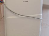 a white and black air purifier sitting on the floor
