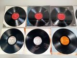 six vinyl records sitting on top of each other on a table