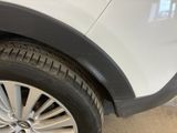 a close up of a tire on a white car