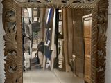 a mirror that is sitting on the floor in a room