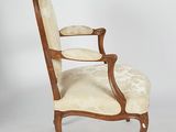 an image of a chair with a wooden frame and upholstered seat