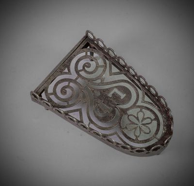 an image of a silver pendant with an intricate design on it