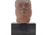 sculpture of a man ' s head on a black stand