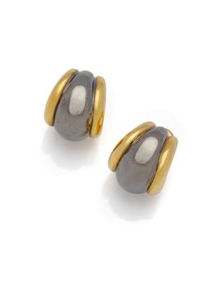 a pair of black and gold earrings on a white background