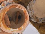 a close up of a vase with a hat on it