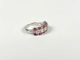 a close up of a white gold ring with pink and white diamonds