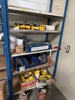 many boxes of tools on the shelves in the room