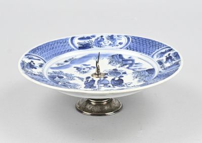 une assiette bleue et blanche sur laquelle figure une horloge