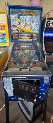 a pinball machine sitting on a table in a room