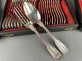 a lot of silver spoons and forks in a box