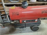 a red propanent sitting on a cart in a garage