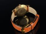 a close up of a wrist watch on a black surface