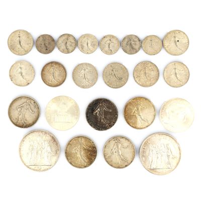 an assortment of old coins on a white surface