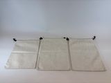 a set of three white towels sitting on top of a white table