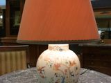 a lamp that is sitting on a table with a lamp shade on it