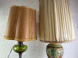 two lamps sitting on a table with a lamp shade on it