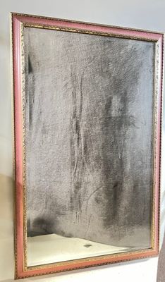 a mirror that is on the wall next to a chair